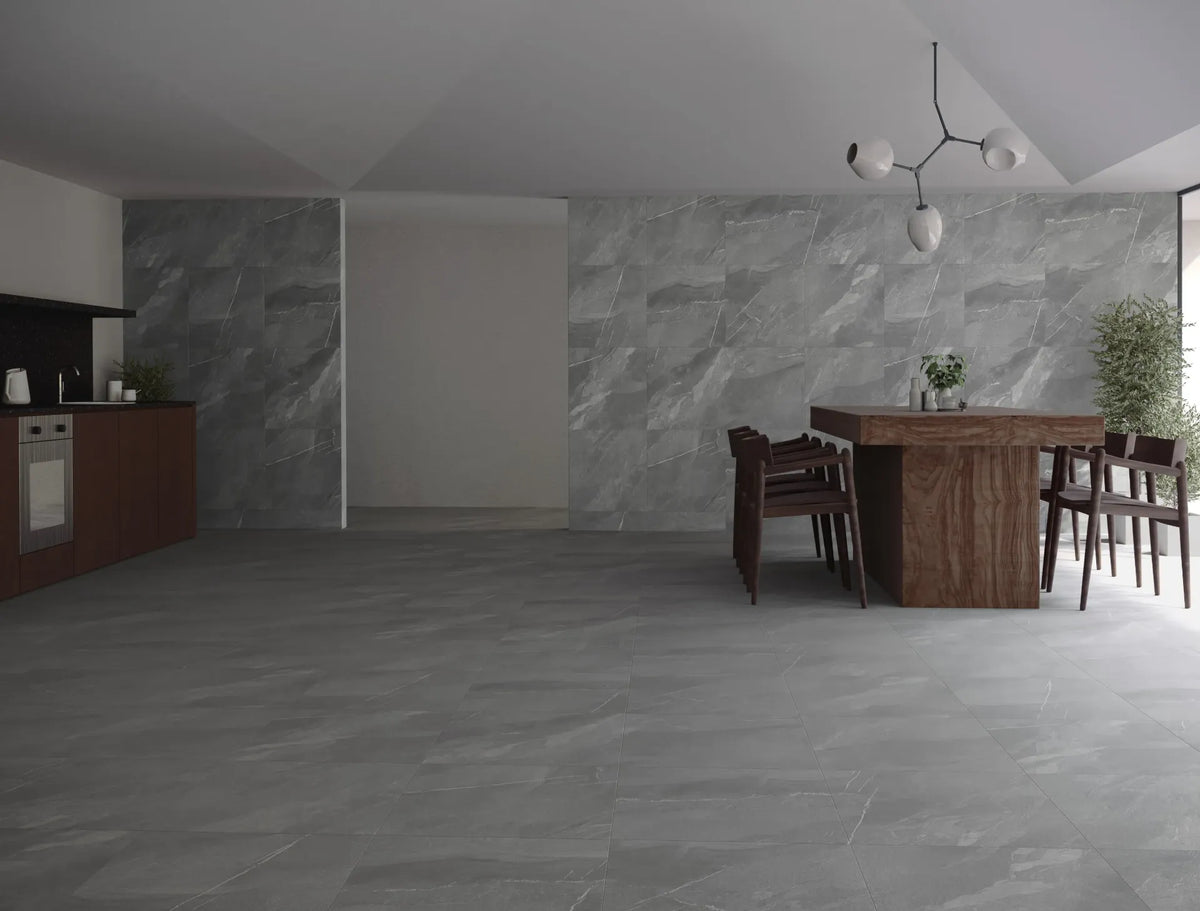 Dovelle Stone matt porcelain tiles in a contemporary open-plan interior, featuring mid-grey tones and subtle light veining across the floor and walls.